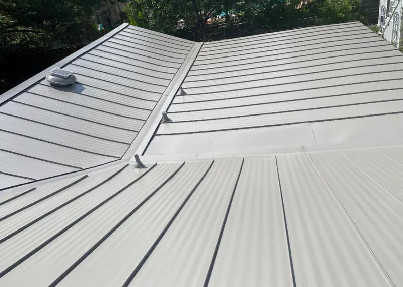 Solar attic fan installed on a metal roof for Roof Ventilation in Brownsville